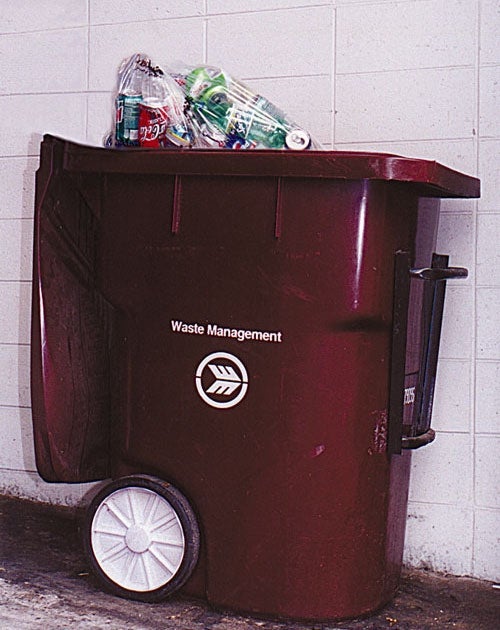 Container Of Recyclables Emptied Into Trash