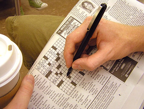 Commuter Playing Some Sort Of Alphabet Sudoku