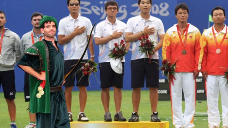 Green-Clad Olympic Archer Steals Gold Medals From Rich, Gives Them To Poor