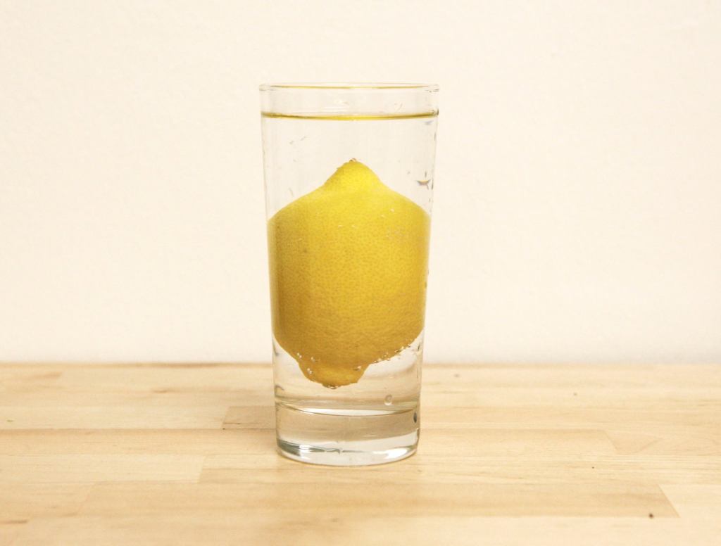 Full Unsliced Lemon Makes Glass Of Water Particularly Refreshing