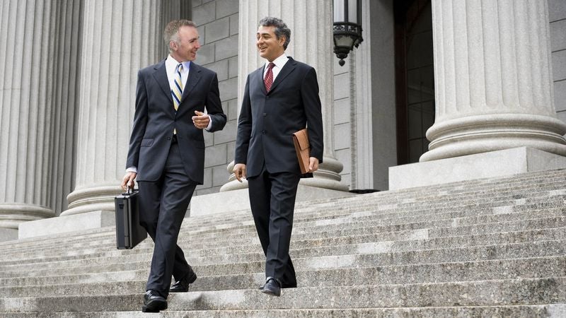 Attorney Friends Catch Up While Briskly Walking Down Courthouse Steps