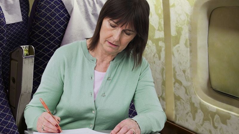 Teacher Grading Papers Next To You On Plane Not Pulling Any Punches