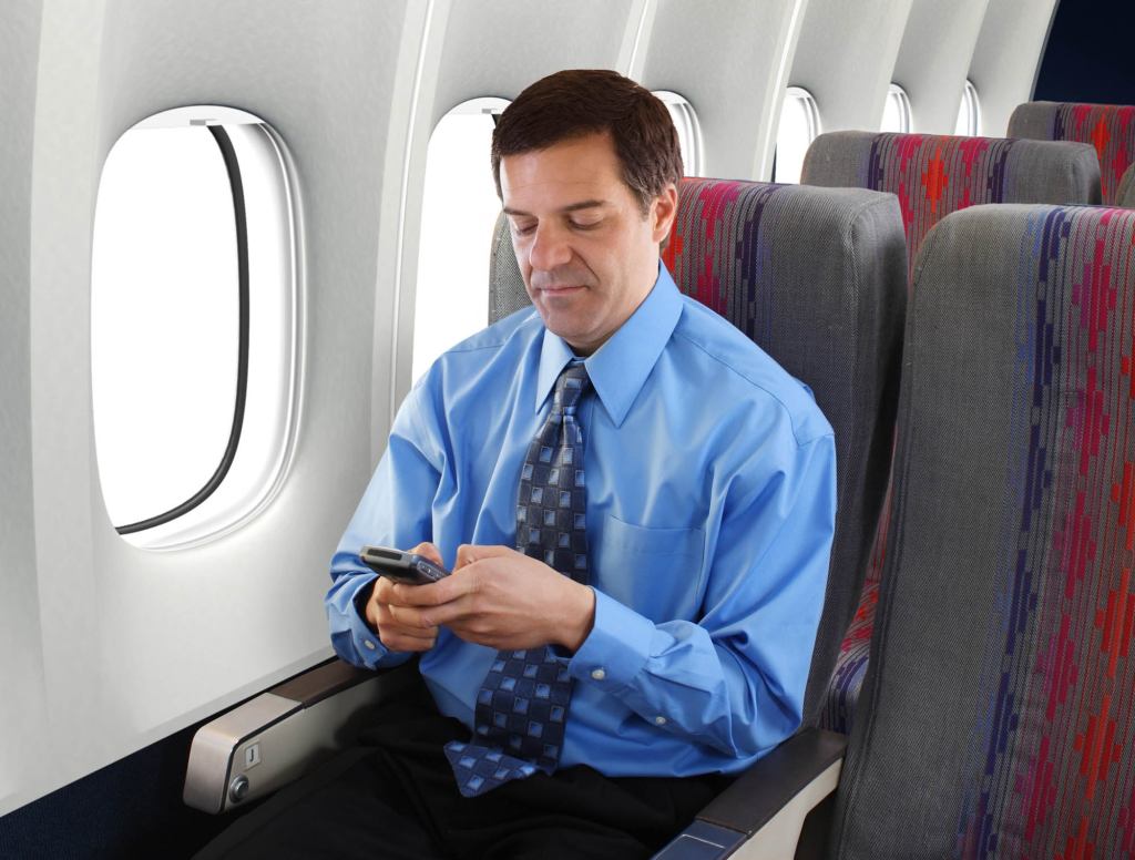 Cranky Businessman Quieted For Entire Trip With Brightly Colored Cell Phone Game