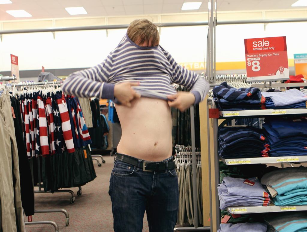 Guy Just Trying On Shirt Right In Middle Of Store