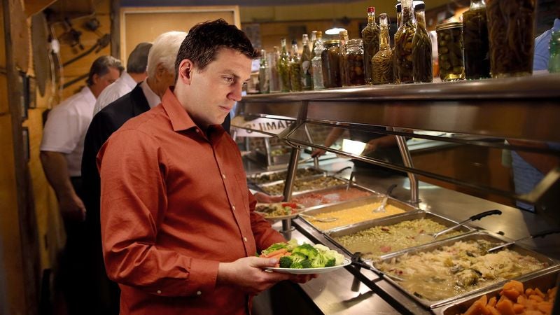 Man Kicking Self For Wasting Valuable Plate Space At Beginning Of Buffet Line