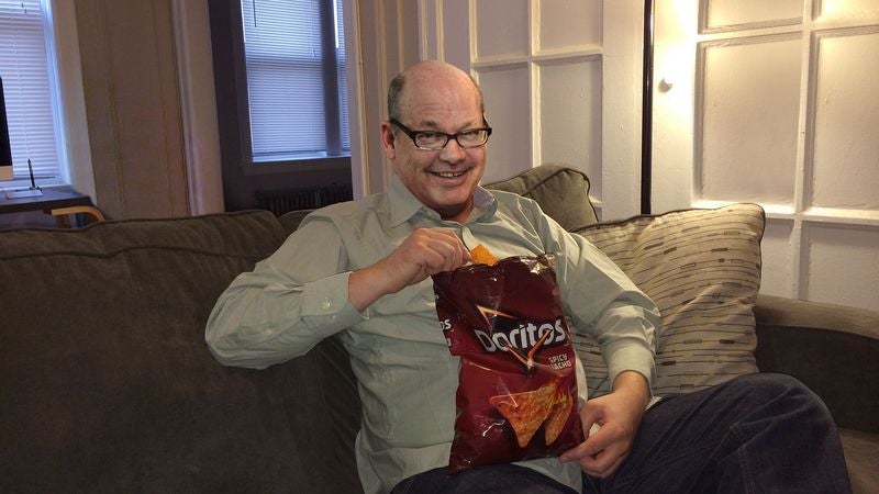 Middle-Aged Man Having Best Snacks Of His Life