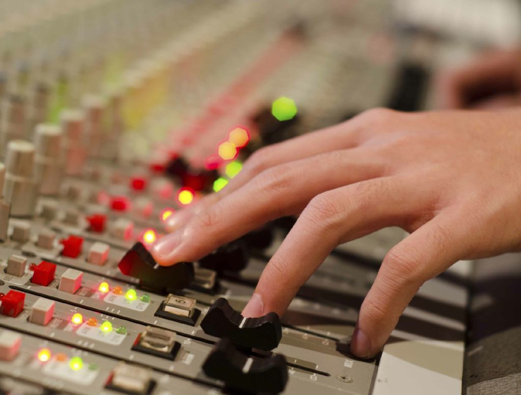 Adjusting Several Sliders On Recording Studio’s Mixing Console Pays Off Big Time