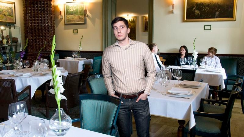 Man Filled With Gratitude At Sight Of Other Customer In Nice Restaurant Wearing Jeans