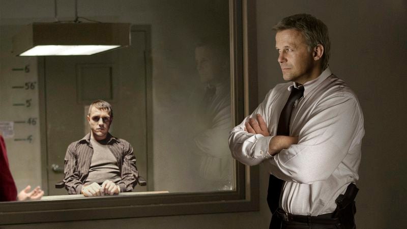 Detective Behind Two-Way Mirror Nervously Crosses Arms As Criminal Addresses Him Directly