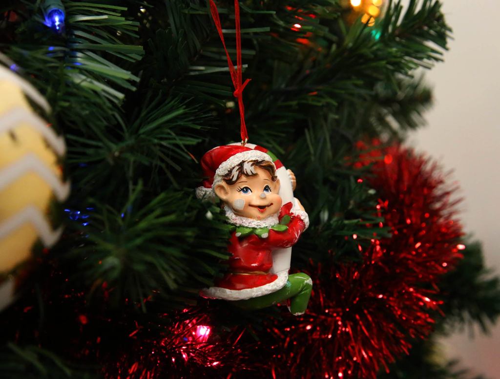 Broken Ornament Relegated To Lonely Existence On Side Of Tree Facing Wall