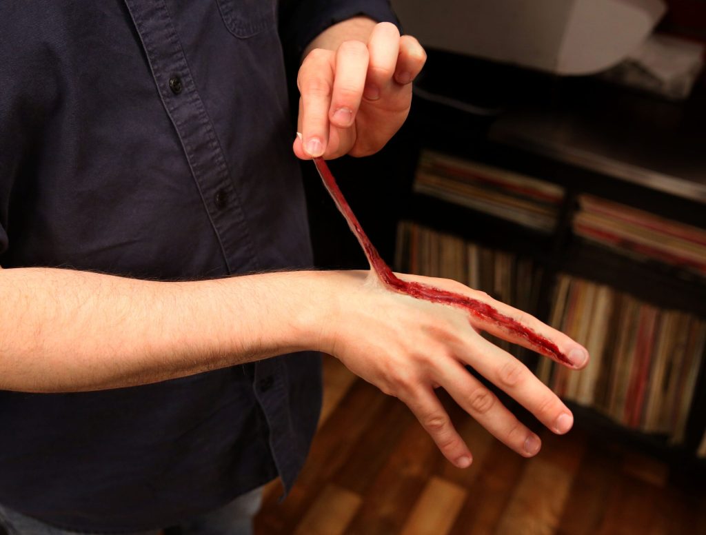 Man Pulling On Loose Hangnail Slowly Unravels Skin From Entire Body