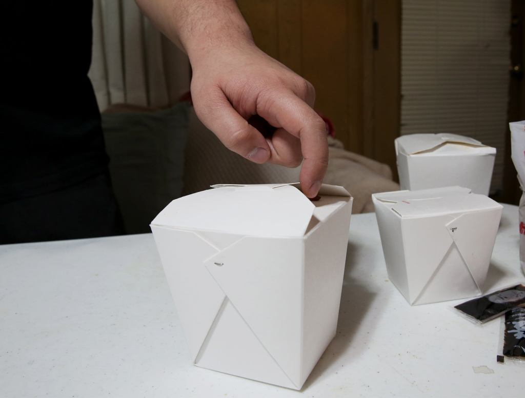 Lustful Man Sensually Uses One Hand To Unhook Clasp Of Take-Out Box