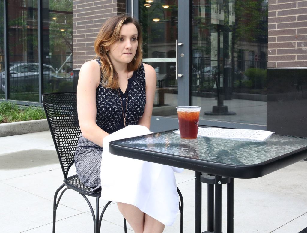 Freezing Woman Dining Outside Desperately Clutching Cloth Napkin For Warmth