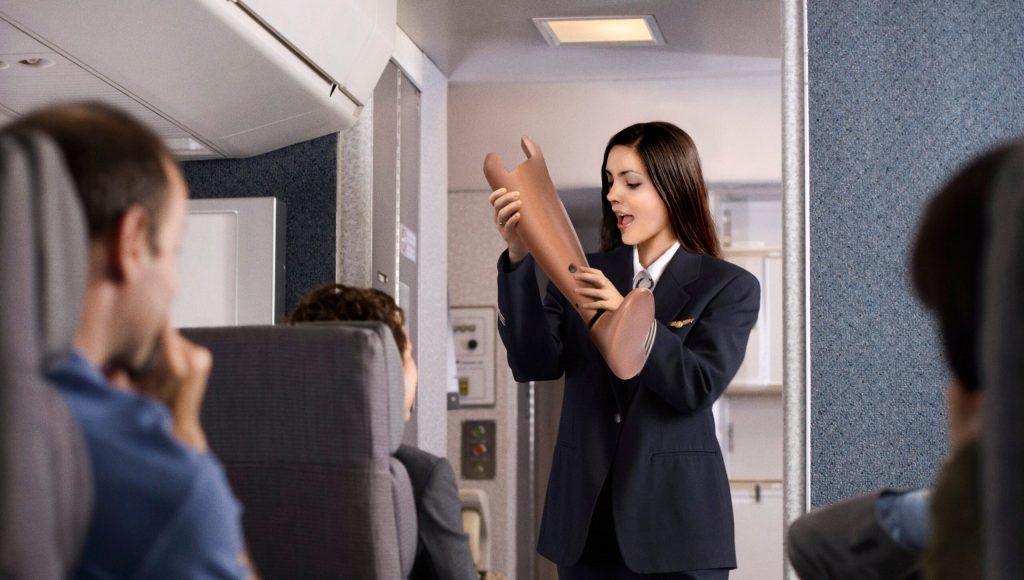 Flight Attendant Demonstrates Proper Technique For Eating Fellow Passenger In Event Of Crash