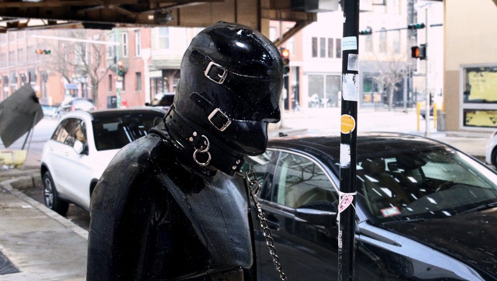 Gimp Tied To Pole On Curb Outside Coffee Shop While Owner Inside