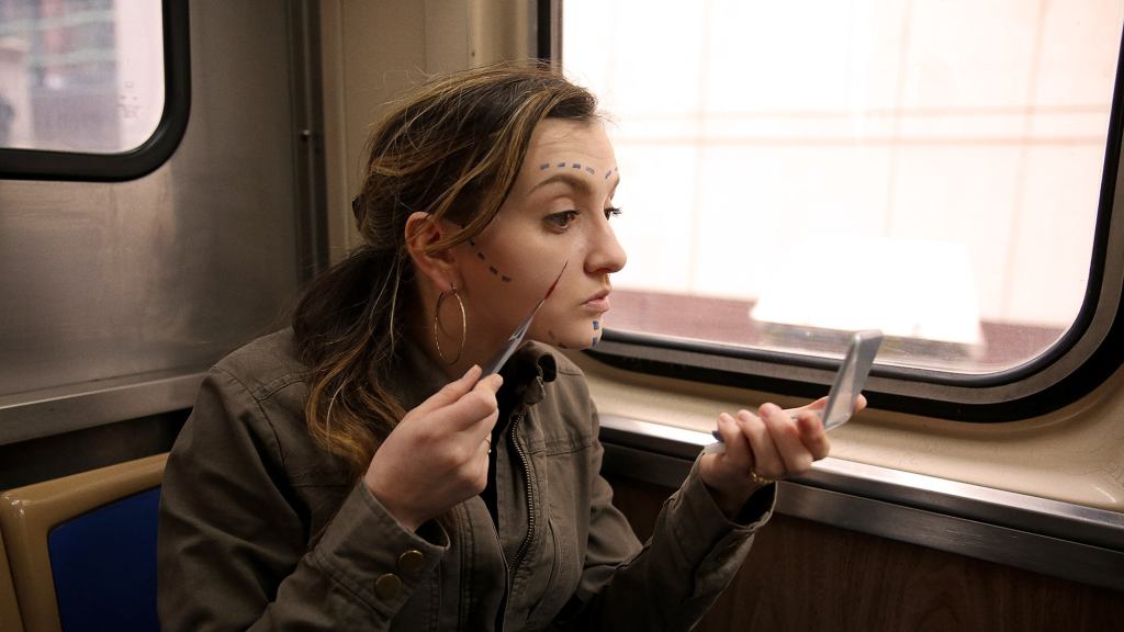 Harried Woman On Train Quickly Doing Plastic Surgery On Face Before Work