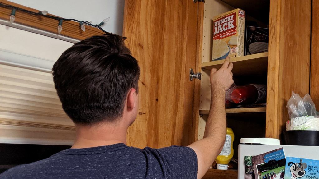 Dwindling Kitchen Resources Forcing Man To Scavenge For Food Higher And Higher In Cabinets