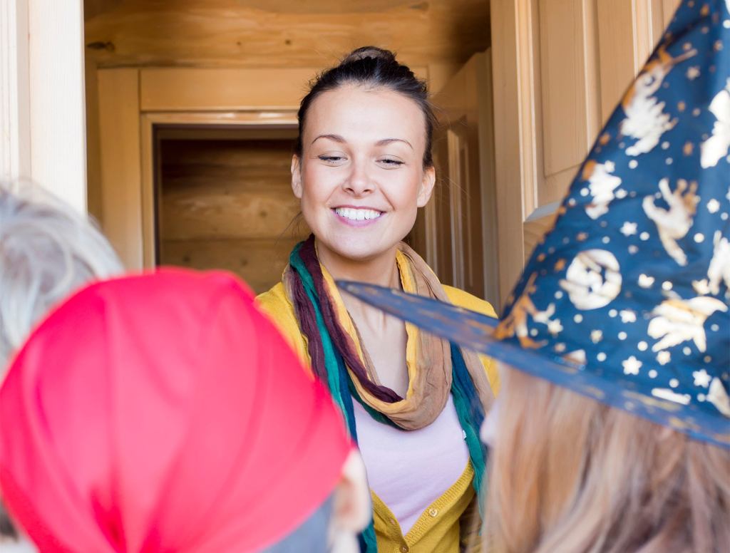 Woman Passing Out Candy Unsure Whether To Give Some To Teen Mom Too