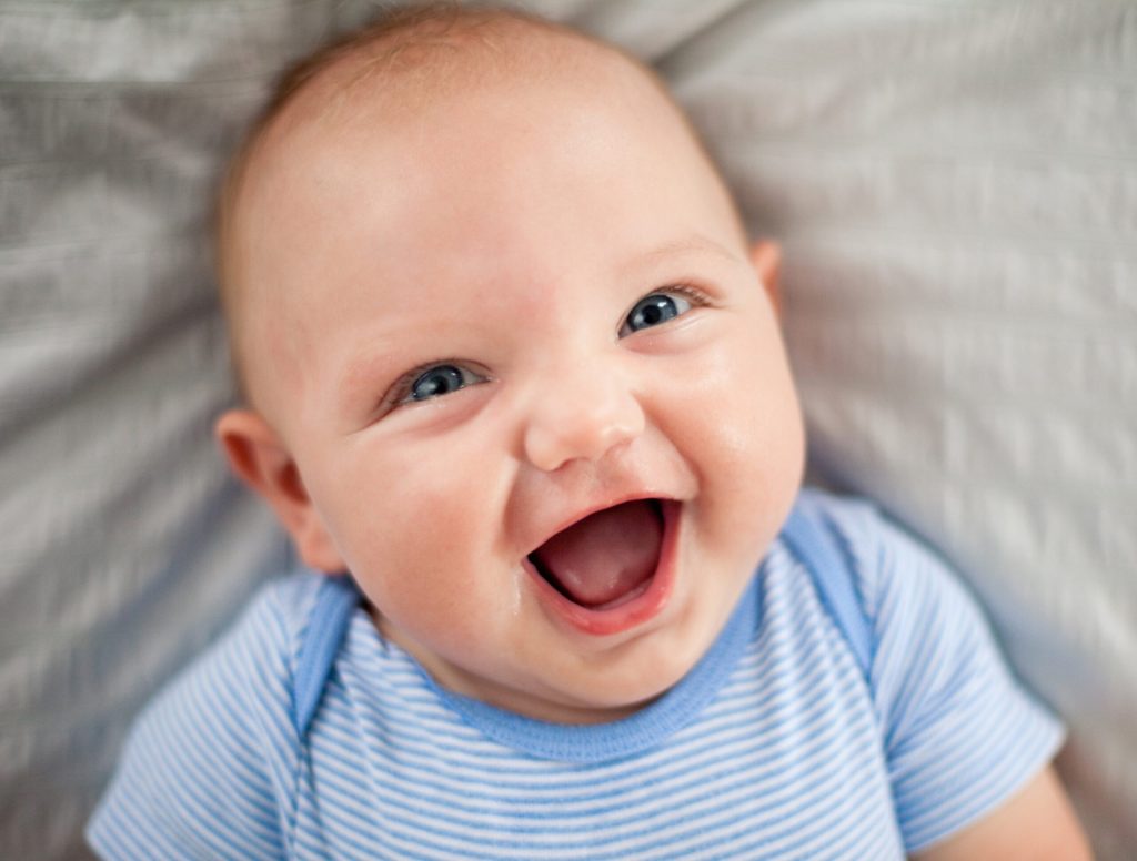 Baby Delighted By Grandfather Making Silly Faces During Stroke