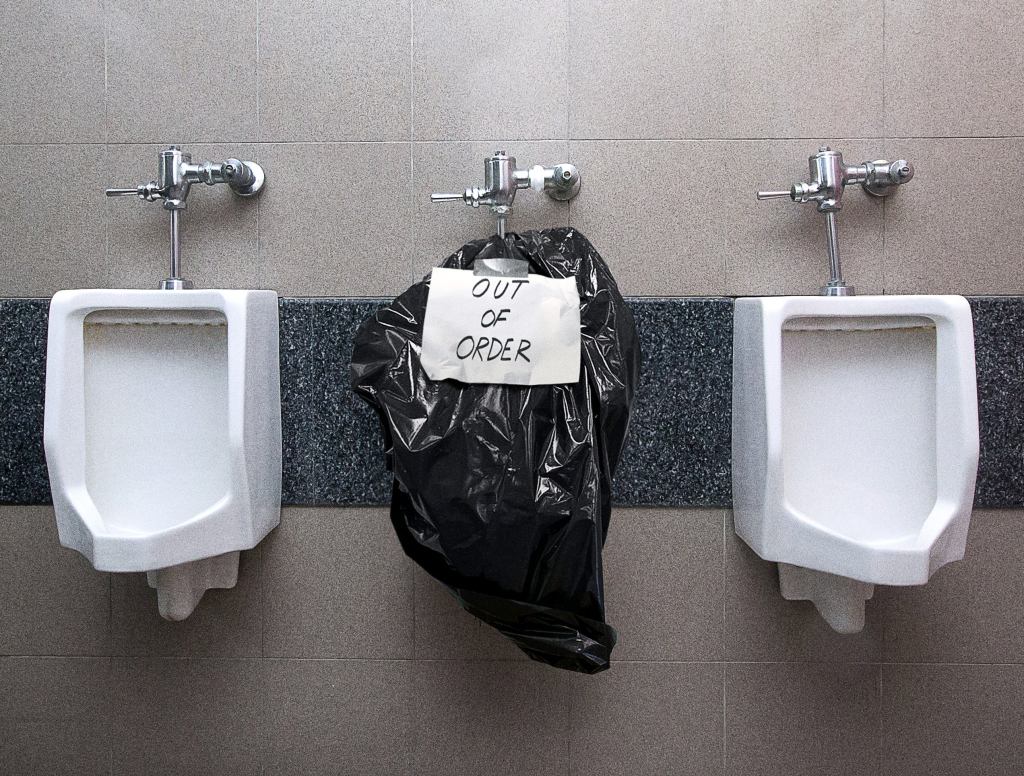 Handwritten Sign Clarifies Flooded Urinal Covered In Garbage Bag ‘Out Of Order’