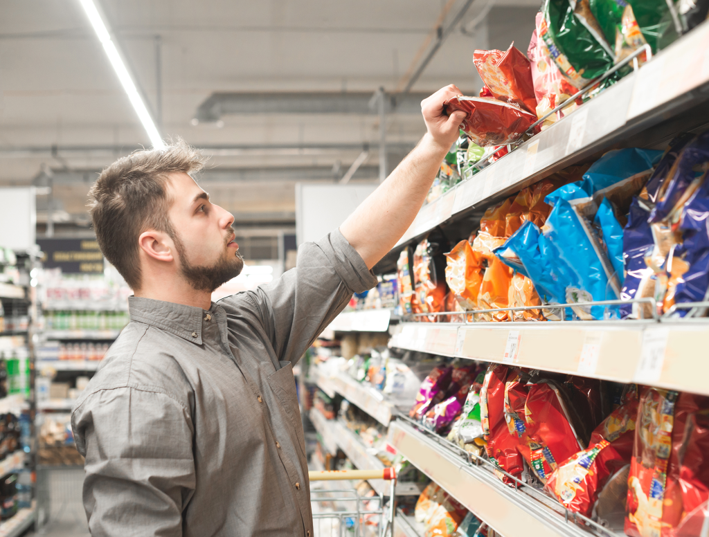 Man Browsing Snack Aisle Lovingly Gazes At Future Killer