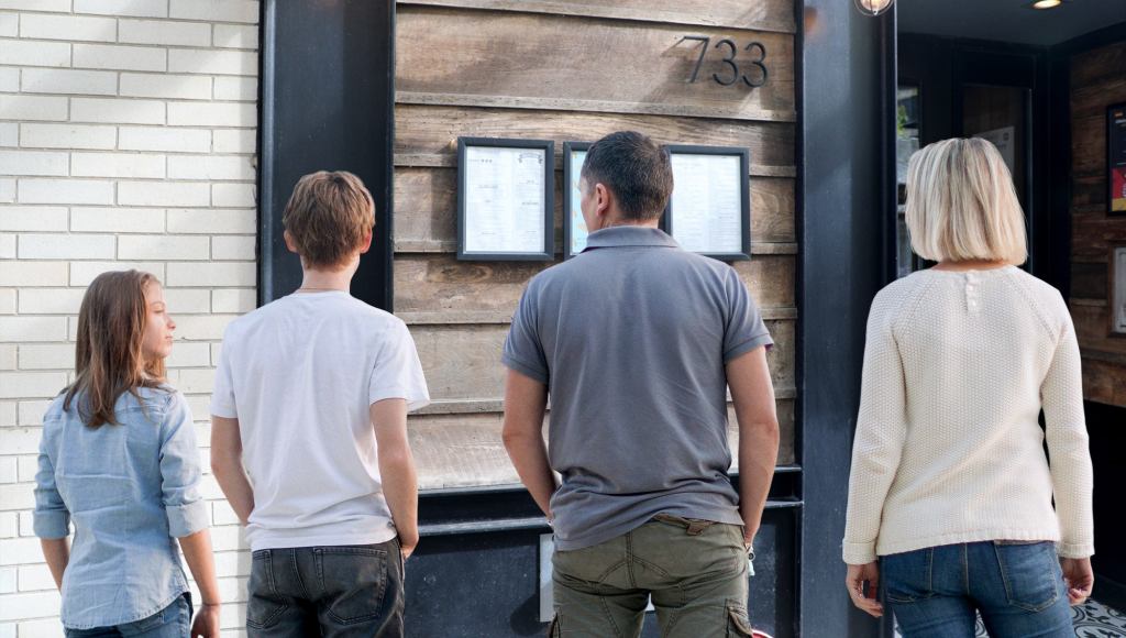 Family Stands In Tense Silence As Dad Considers Menu Posted Outside Bistro