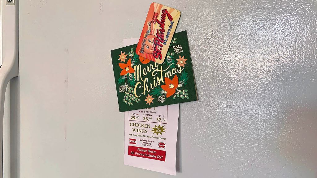 More Fridge Magnets Forced To Take On Extra Holiday Work Holding Up Christmas Cards