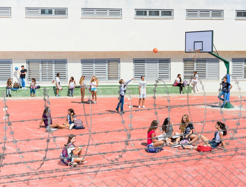 Schoolyard Has Barbed Wire Fence