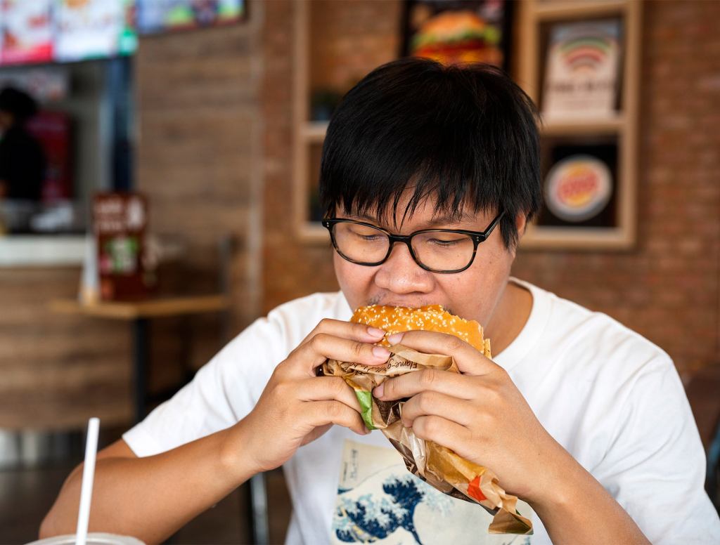 Man Biting Into Messy Sandwich Lets Out Little Whimper Of Capitulation To Falling Condiments