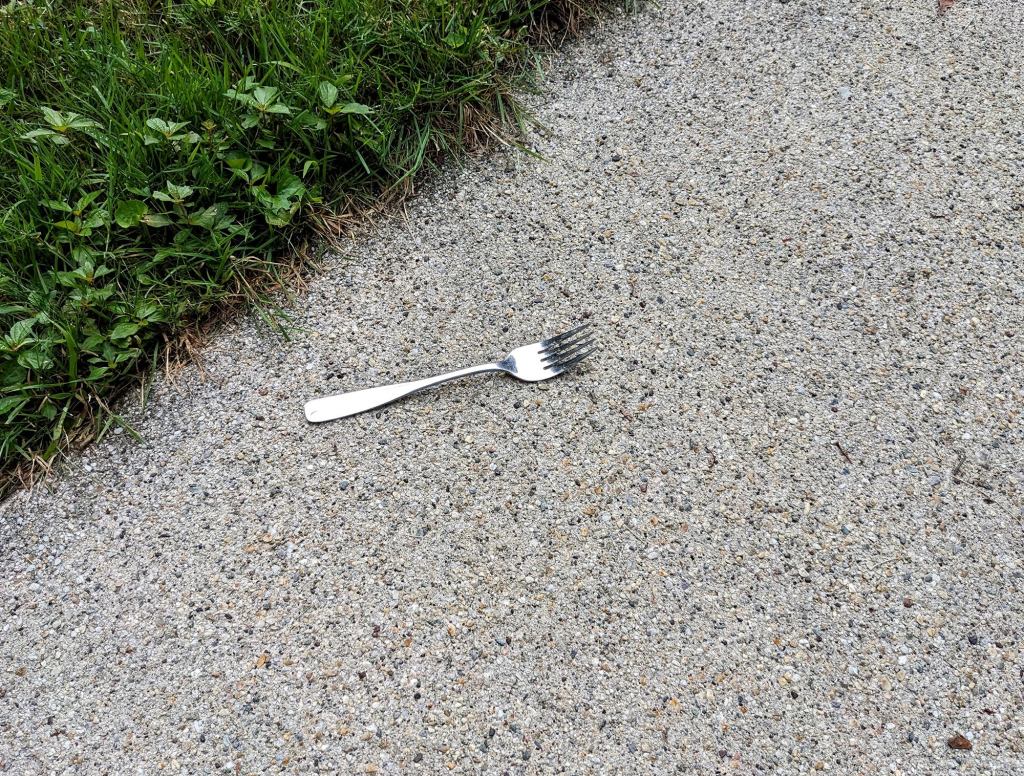 Metal Fork Just On Sidewalk