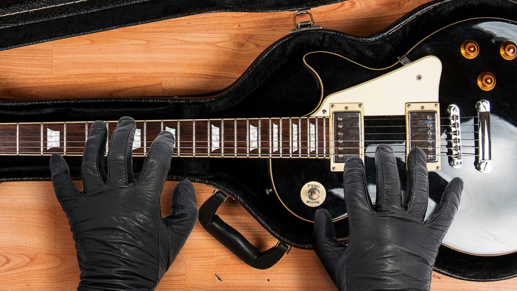 Hit Man Opens Guitar Case Concealing Guitar He Going To Beat Target’s Ass With