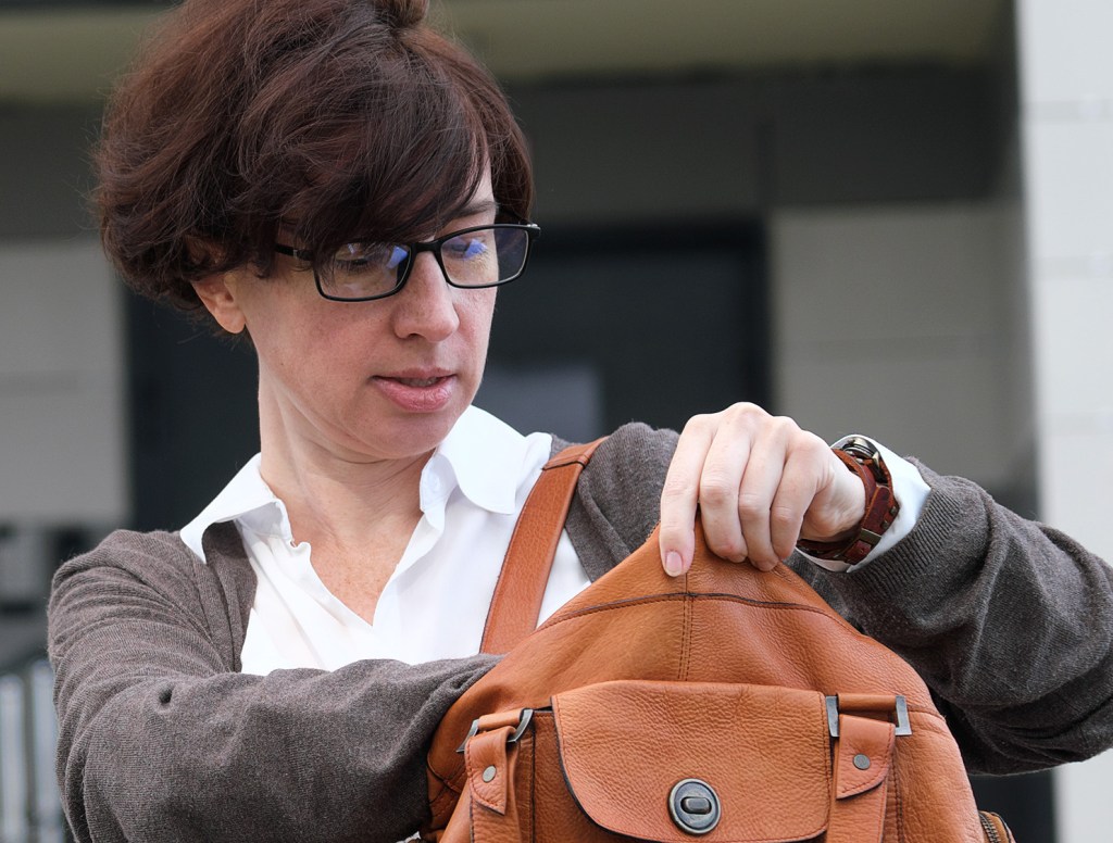 Woman Reaches Arm Deep Into Purse Like Farmer Artificially Inseminating Cow